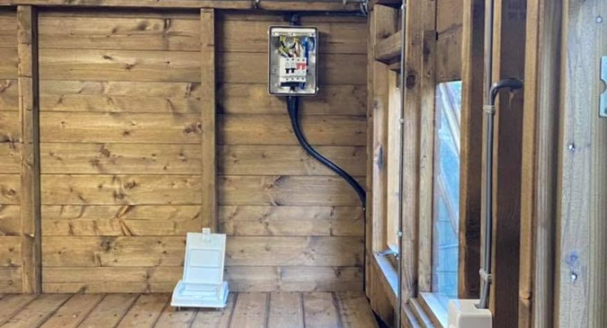 Do I need an electrician to install outbuilding electrics? A guide for homeowners in Blackwater